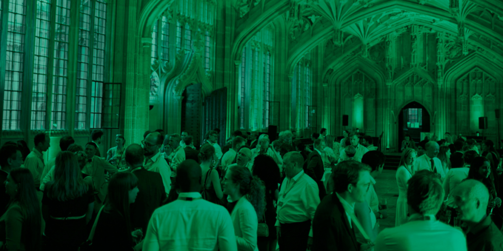 picture of crowd in a church-like room with a green tint over