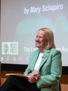 Mary Schapiro wearing a green jacket and smiling